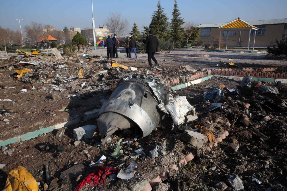 (FILES) In this file photo taken on January 8, 2020 rescue teams work amidst debris after a Ukrainian plane carrying 176 passengers crashed near Imam Khomeini airport in the Iranian capital Tehran early in the morning on January 8, killing everyone on boa