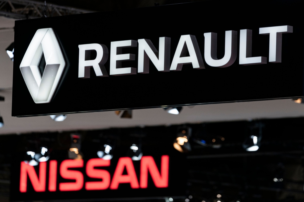 Renault and Nissan autocar logos are pictured during the Brussel Motor Show on January 09, 2020 in Brussel. / AFP / Kenzo Tribouillard 