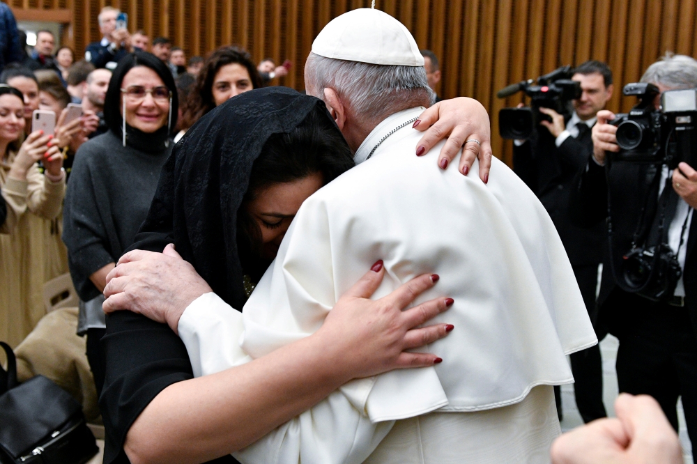 Pope Francis hugs a woman during the weekly general audience at the Vatican, January 15, 2020. Vatican Media handout via Reuters