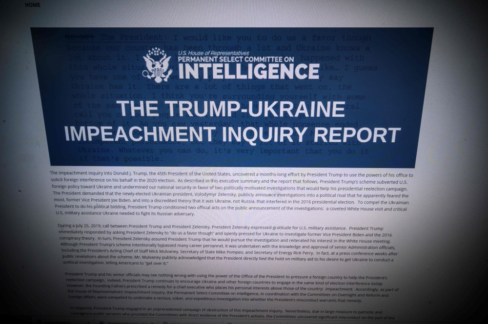 This omputer screen shows a copy of the Permanent Select Committee on Intelligence Report of The Trump-Ukraine Impeachment Inquiry Report on December 3, 2019 in Washington. AFP / Eric Baradat