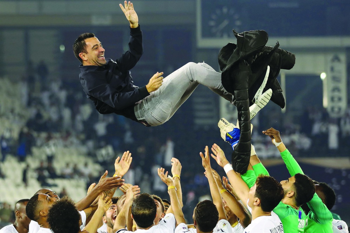 Al Sadd coach Xavi Hernandez is thrown into the air by his players as they celebrate winning the Qatar Cup final against Al Duhail at the Jassim Bin Hamad Stadium on Friday.