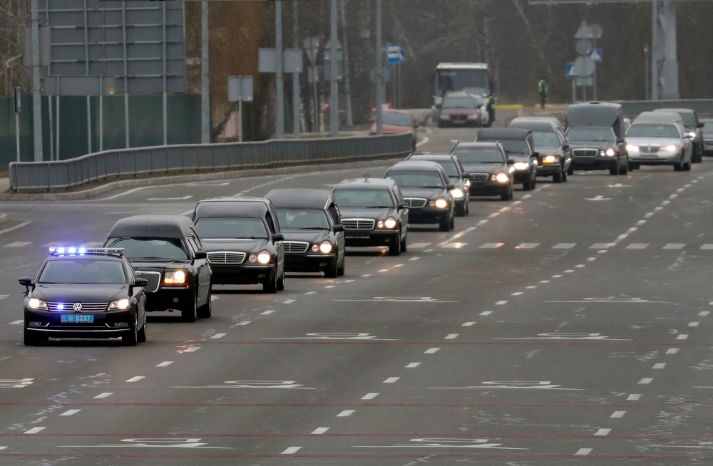 A motorcade of hearses carrying the bodies of the eleven Ukrainian victims of the Ukraine International Airlines flight 752 plane disaster moves along a road before a memorial ceremony at the Boryspil International Airport outside Kiev, Ukraine January 19