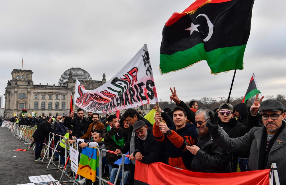 A protest with Stop war in Libya banner in front of the Reichstag building during the Peace summit on Libya at the Chancellery in Berlin on January 19, 2020. AFP / John MacDougall 