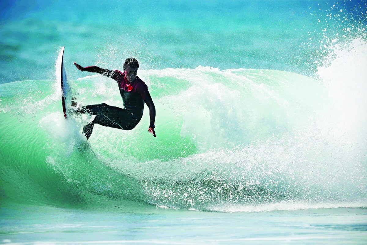 In this file photo taken on October 01, 2019 a surfer makes a turn as he rides the wave in the ocean at Omaezaki on. AFP / Adrian Dennis