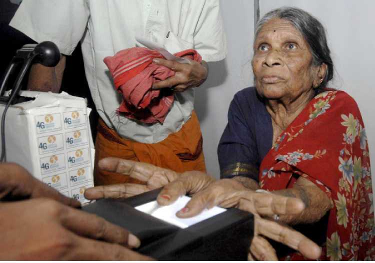A villager goes through the process of a fingerprint scanner during Unique Identification database system in the Pathancheru village in Medak district of Andhra Pradesh, April 27, 2010. Reuters / Krishnendu Halder