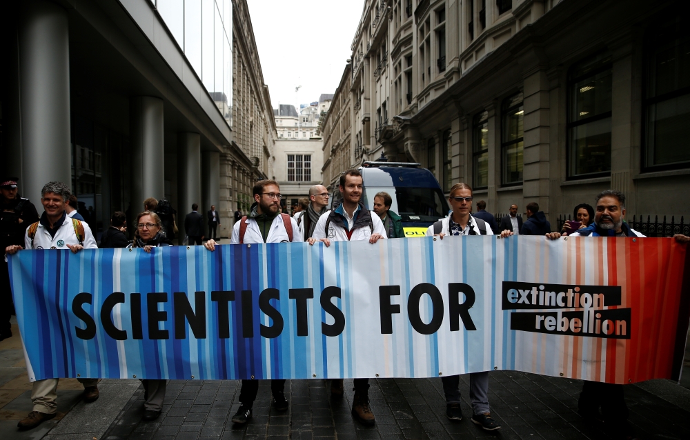 Protesters hold a banner outside the BlackRock office during an Extinction Rebellion demonstration in the City of London, Britain, October 14, 2019. Reuters / Henry Nicholls