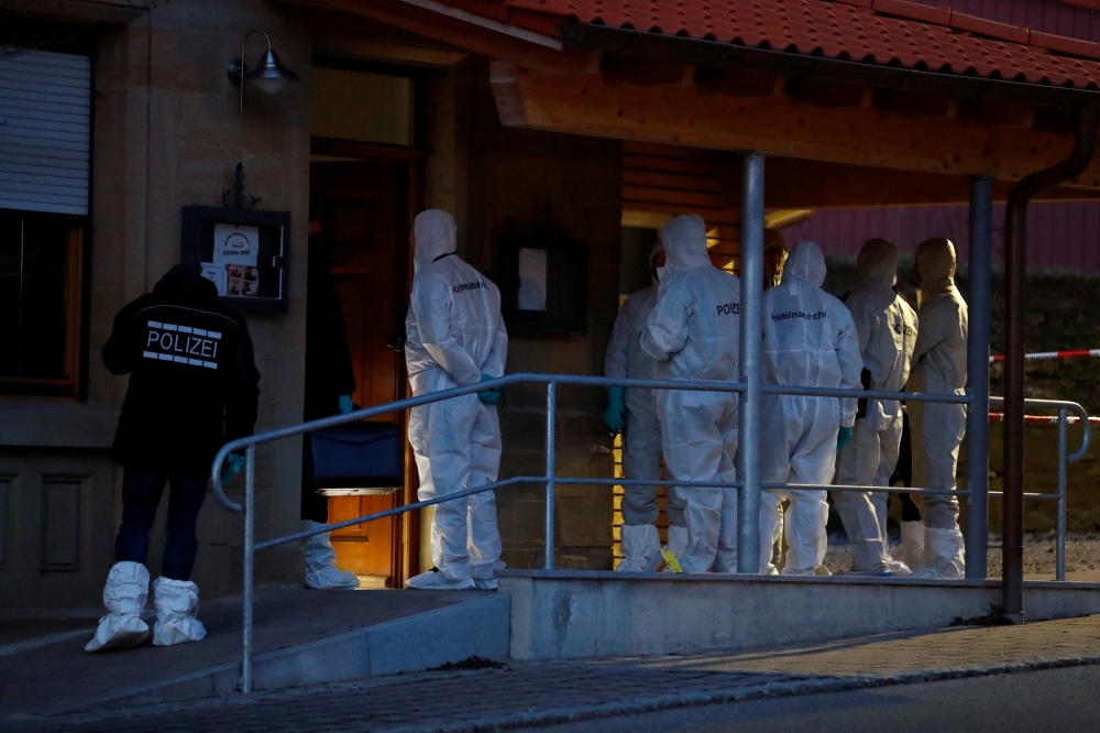 Police officers and forensic experts stand in front of the house where a shooting took place, in Rot am See, Germany, January 24, 2020. Reuters/Ralph Orlowski