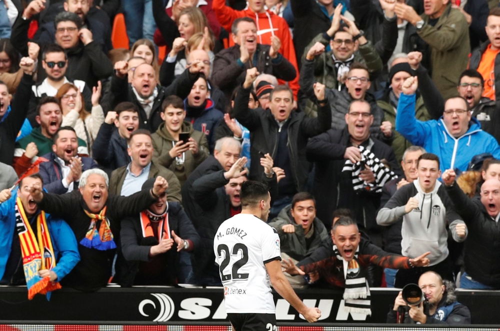 Valencia's Maxi Gomez celebrates after Barcelona's Jordi Alba scored an own goal and Valencia's first REUTERS/Albert Gea