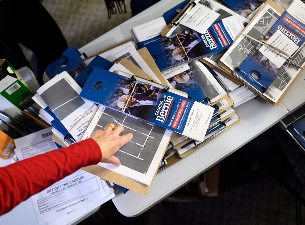 A volunteer points to canvassing materials at the Bernie Sanders presidential campaign field office in Cedar Rapids, Iowa on January 25, 2020. AFP / Stephen Maturen  