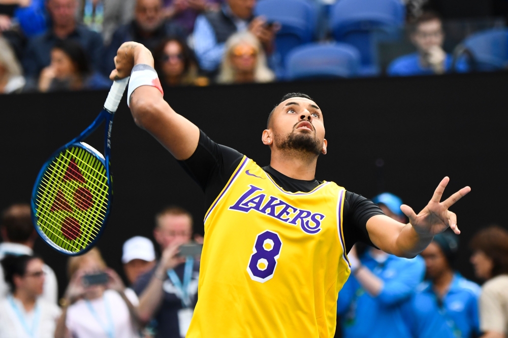 Australia's Nick Kyrgios wearing a Los Angeles Lakers jersey with former basketball player Kobe Bryant's number warms up to play against Spain's Rafael Nadal during their men's singles match on day eight of the Australian Open tennis tournament in Melbour