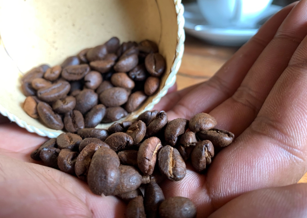 Jacques Ramarlah, a farmer and agricultural entrepreneur displays samples of Bourbon pointu coffee variety at the Kafen Drazana packaging factory in Ampefy town of Itasy region, Madagascar January 24, 2020. Picture taken January 24, 2020. REUTERS/Clarel F