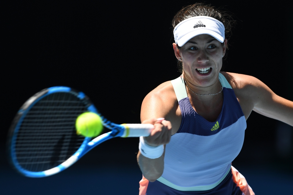 Spain's Garbine Muguruza hits a return against Russia's Anastasia Pavlyuchenkova during their women's singles quarter-final match on day ten of the Australian Open tennis tournament in Melbourne on January 29, 2020. AFP / Greg Wood 