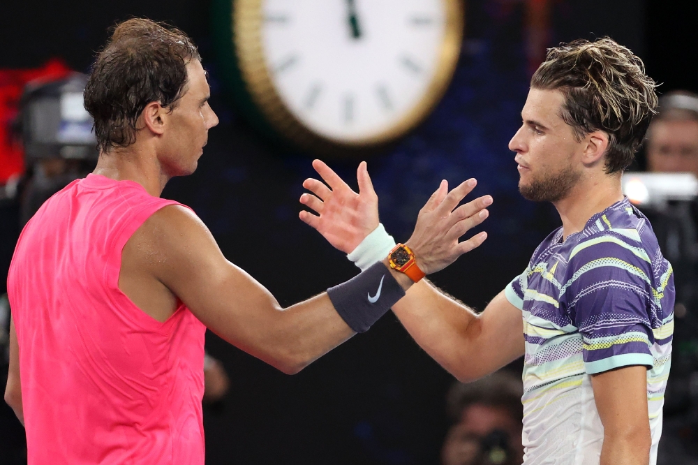 Spain's Rafael Nadal (L) congratulates Austria's Dominic Thiem on his victory in their men's singles quarter-final match on day ten of the Australian Open tennis tournament in Melbourne on January 30, 2020.