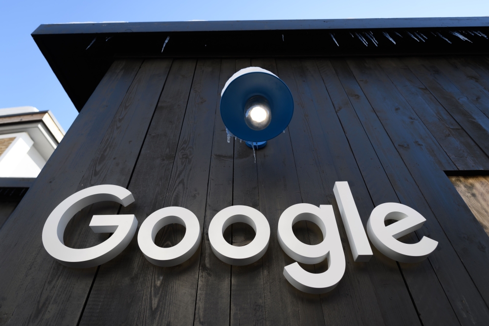 FILE PHOTO: In this file photo taken on January 20, 2020 a Google logo is seen on the brand's stand ahead of the annual meeting of the World Economic Forum (WEF) in Davos.  AFP / Fabrice COFFRINI