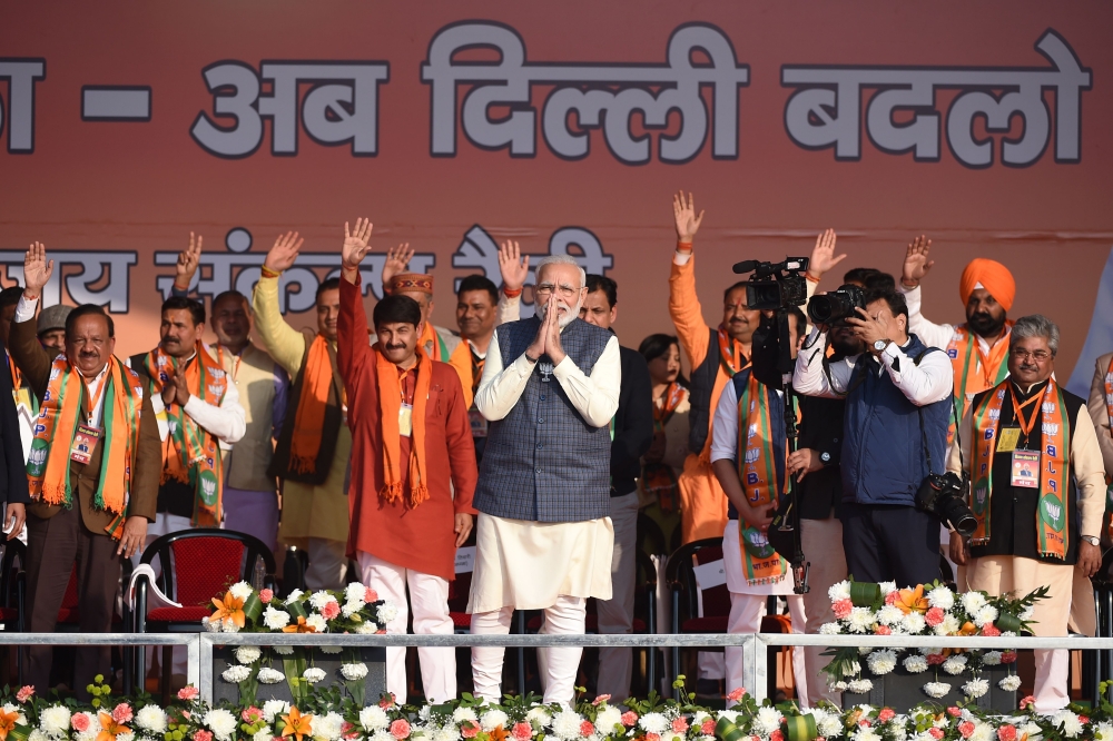 Indian Prime Minister Narendra Modi (C) greets supporters during a rally for the upcoming Delhi Legislative Assembly election, in New Delhi on February 3, 2020. AFP / Money Sharma
 