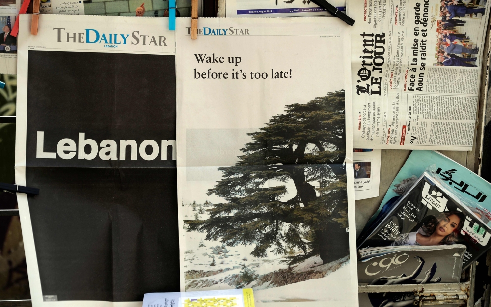 :(FILES) A file photo taken on August 08, 2019, shows the front pages of the Lebanese local English-language newspaper 