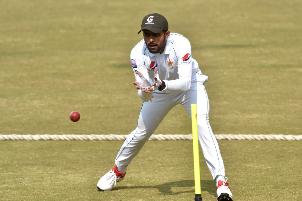 :Pakistani cricket team captain Babar Azam tries to catch a ball during a practise session in Lahore on February 1, 2020.  Pakistan on february 1 recalled allrounder Faheem Ashraf and off-spinner Bilal Asif for the first Test against Bangladesh starting i
