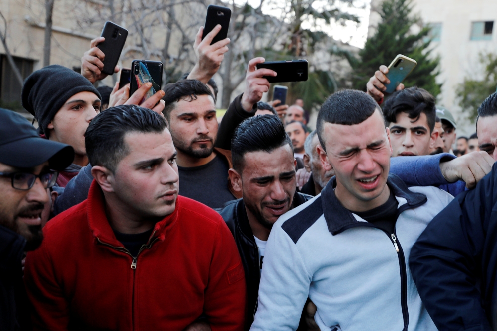 Relatives of 17-year-old Palestinian Mohammed Al-Hadad react at a hospital in Hebron in the Israeli-occupied West Bank February 5, 2020. Reuters/Mussa Qawasma
 
