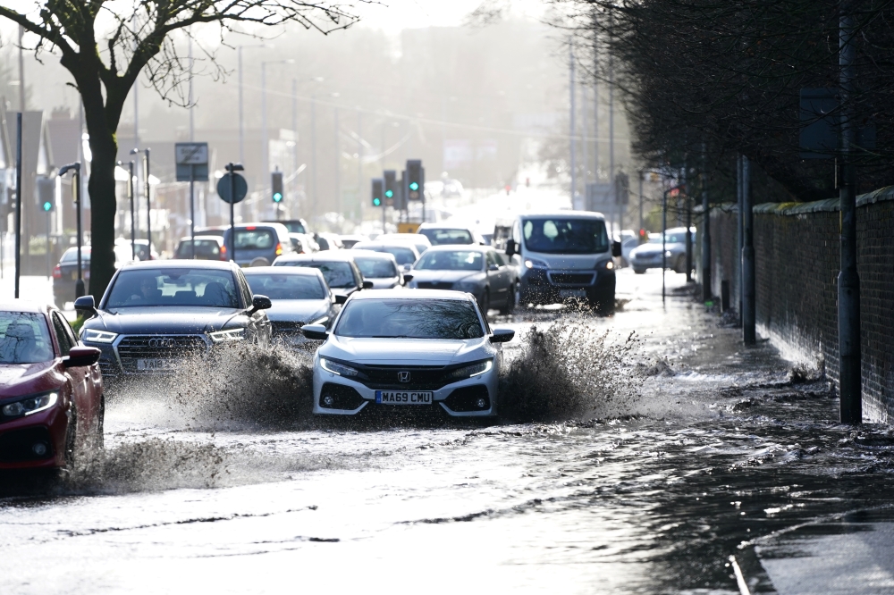 Cars drive through floodwater as hurricane-force winds and rain affected the country's transport network leading to disruptions and prompting warnings of power cuts and a risk to life, in Manchester, Britain February 9, 2020. Reuters/Jon Super
 