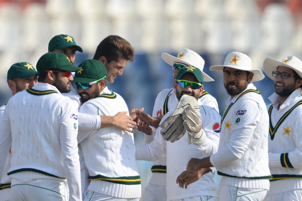 Pakistan's cricketers celebrater after the dismissal of Bangladesh's Mominul Haque during the fourth day of the first cricket Test match between Pakistan and Bangladesh at the Rawalpindi Cricket Stadium in Rawalpindi on February 10, 2020. / AFP / AAMIR QU