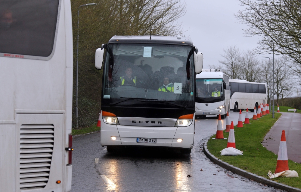 A convoy of coaches carrying British nationals evacuated from Wuhan in China amid the novel coronavirus outbreak, arrives at Kents Hill Park conference centre and hotel in Milton Keynes, north of London on February 9, 2020, where they will be kept in isol