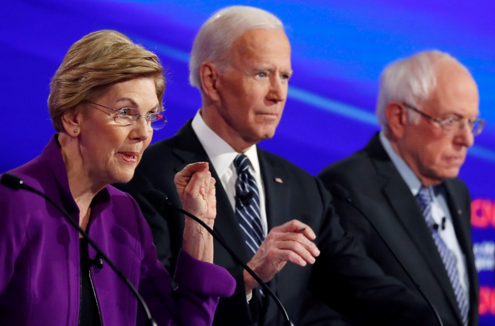 Elizabeth Warren speaks as Joe Biden and Bernie Sanders listening at the seventh Democratic 2020 presidential debate at Drake University in Des Moines, Iowa, US, January 14, 2020. Reuters / Shannon Stapleton