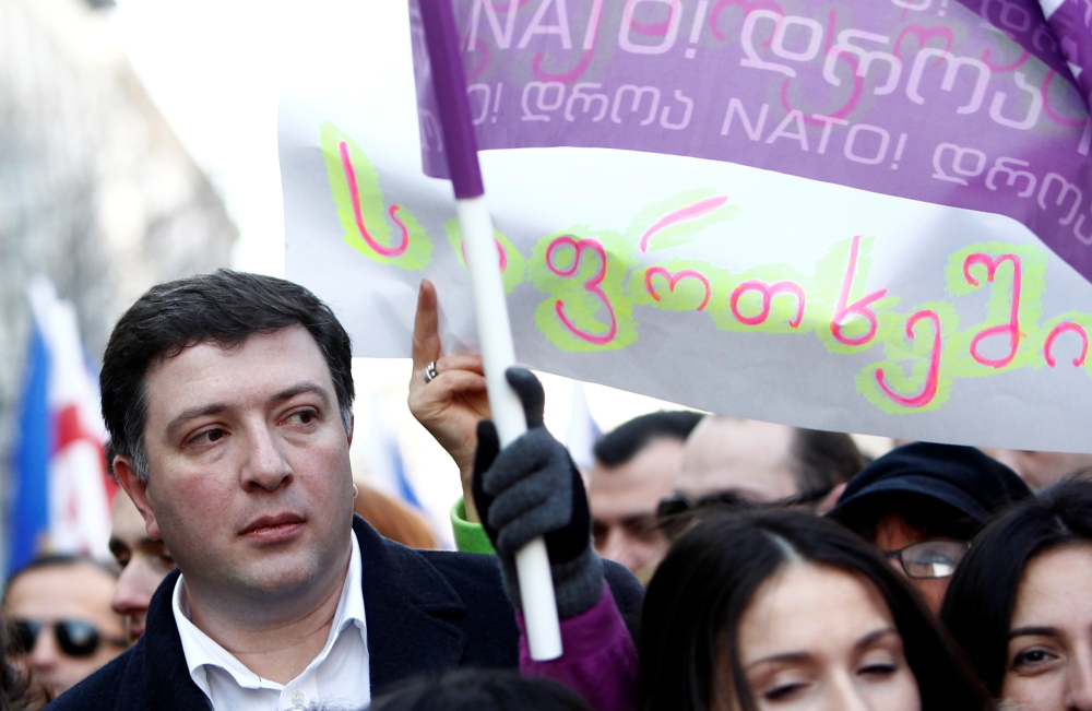Gigi Ugulava marches with supporters of the opposition United National Movement along a street in Tbilisi on December 28, 2013, shortly after being suspended as mayor of the Georgian capital. Reuters/David Mdzinarishvili