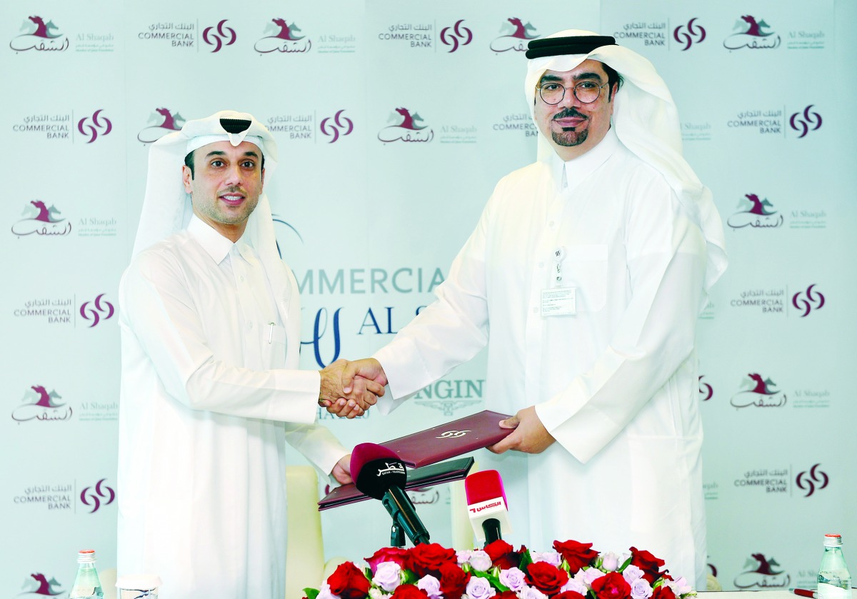 Hussein Ali Al Abdulla, (right) EGM and Chief Marketing Officer, Commercial Bank,  and  Omar Al Mannai, Commercial Manager Al Shaqab and Event Director CHI Al Shaqab, pose for a picture after the signing ceremony. Pic: Abdul Basit/The Peninsula