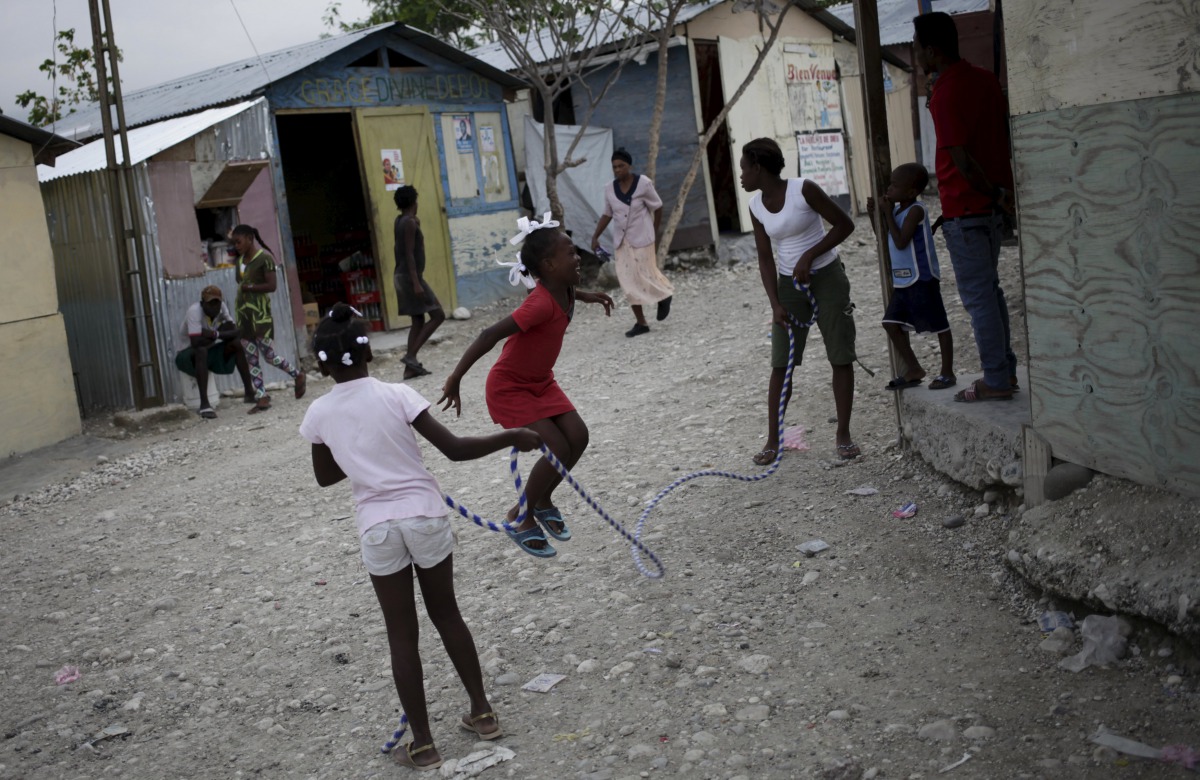 Girls play at a camp for displaced people in Port-au-Prince, Haiti, March 6, 2016. Reuters / Andres Martinez Casares