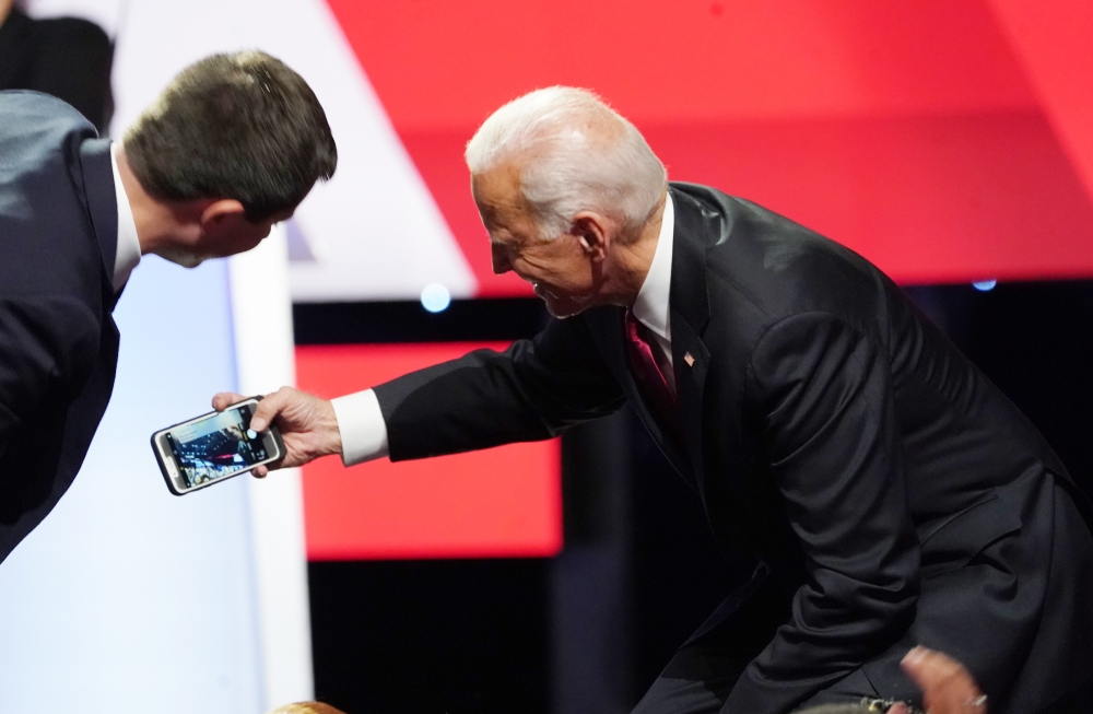 Pete Buttigieg leans in to a selfie by Joe Biden with the crowd at the end of the fourth US Democratic presidential candidates 2020 election debate at Otterbein University, October 15, 2019. Reuters / Shannon Stapleton