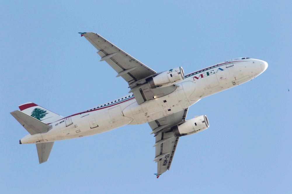 FILE PHOTO: A Lebanese Middle East Airlines (MEA) Airbus A320-200 plane flies over Beirut, Lebanon January 12, 2017. REUTERS/Mohamed Azakir