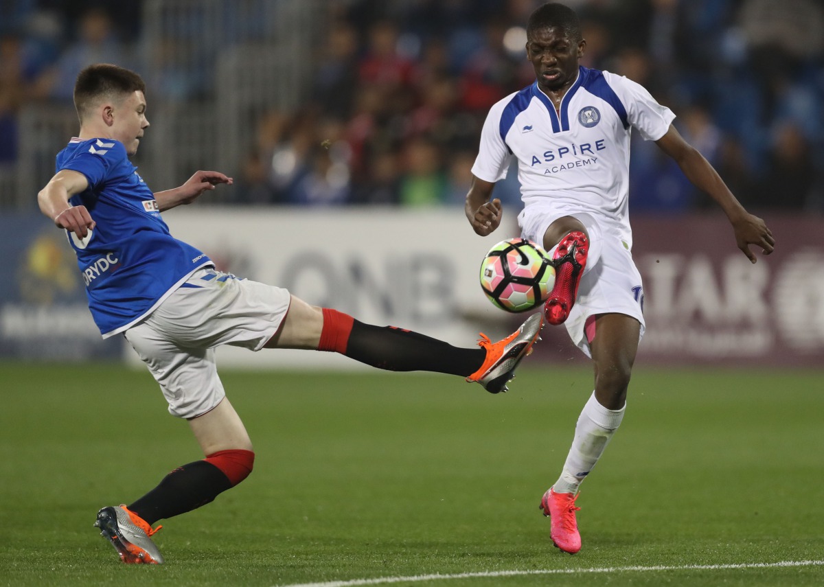 The players of Aspire Academy and Glasgow Rangers in action during the Al Kass International Cup at Aspire Academy yesterday.