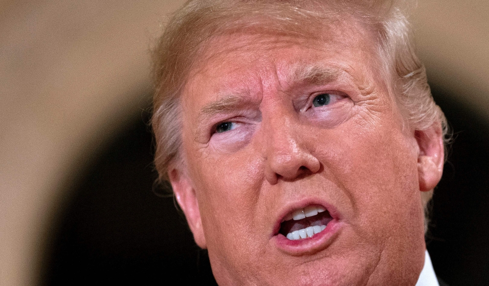 US President Donald Trump speaks to the press outside the grand ballroom as he arrives for a New Year celebration at Mar-a-Lago in Palm Beach on December 31, 2019. AFP / Jim Watson