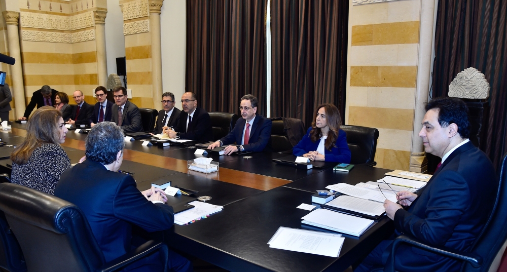  shows Prime Minister Hassan Diab  meeting with a delegation from the International Monetary Fund (IMF) at the Grand Serail in Beirut on February 19, 2020 .(AFP PHOTO / DALATI AND NOHRA)