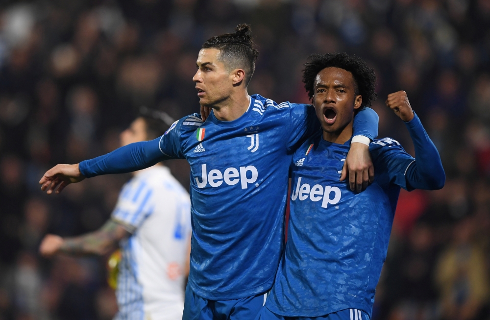 Juventus' Cristiano Ronaldo celebrates scoring their first goal with Juan Cuadrado REUTERS/Alberto Lingria