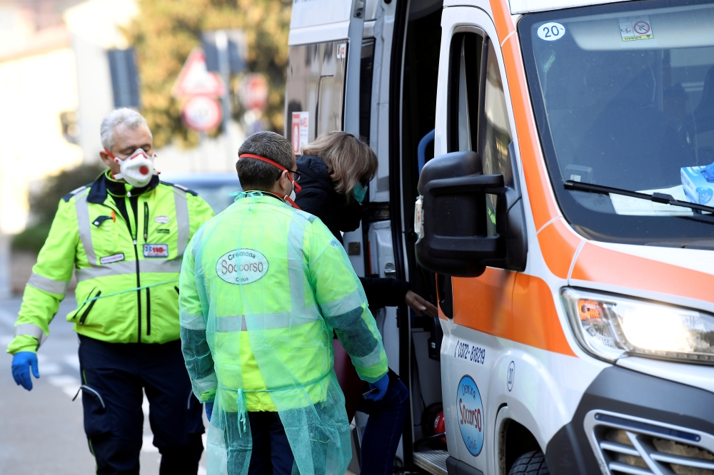 A woman is taken into an ambulance amid a coronavirus outbreak in northern Italy, in Casalpusterlengo, February 22, 2020. REUTERS/Flavio Lo Scalzo