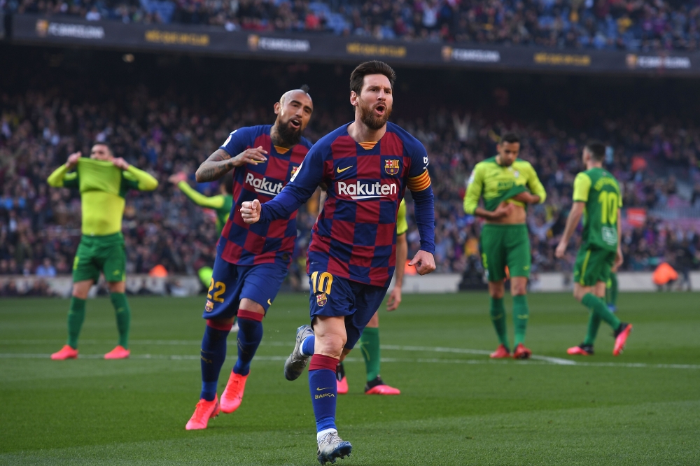 Barcelona's Argentine forward Lionel Messi (R) celebrates after scoring during the Spanish league football match FC Barcelona against SD Eibar at the Camp Nou stadium in Barcelona on February 22, 2020. / AFP / Josep LAGO