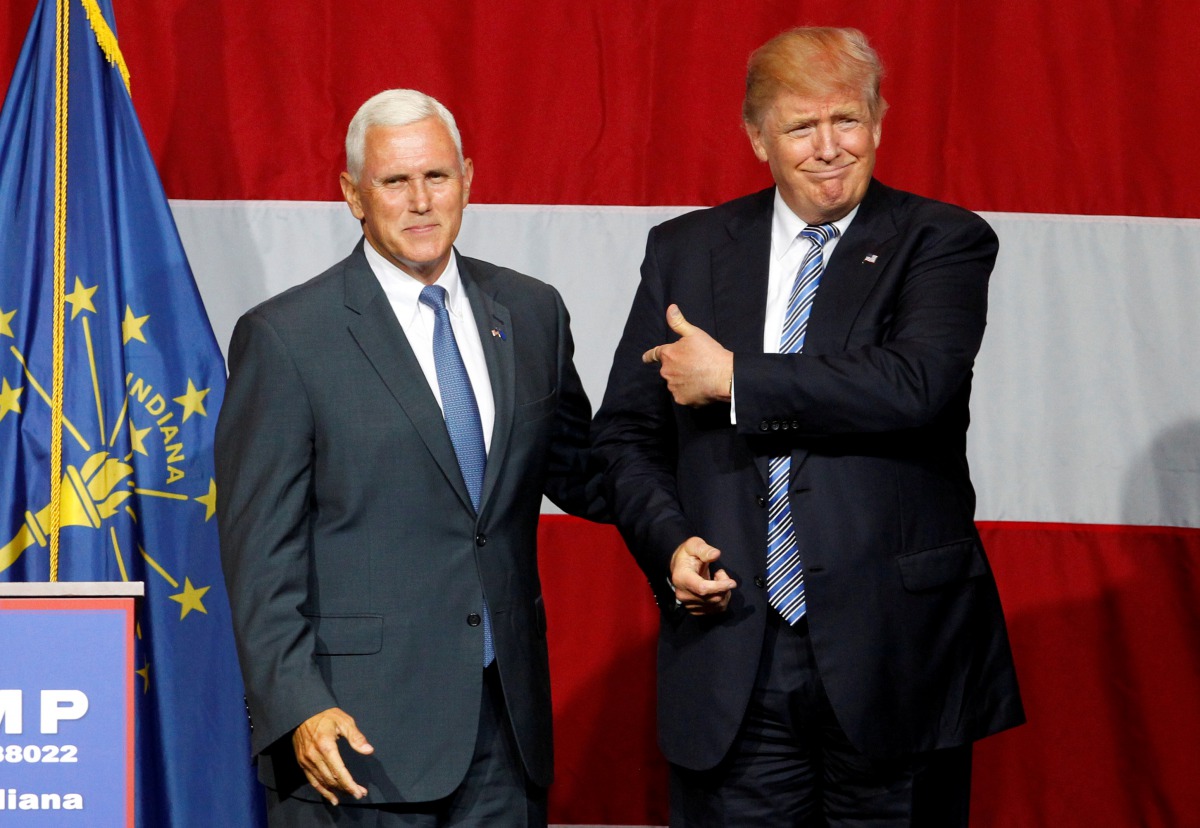 Donald Trump and Mike Pence wave to the crowd before addressing the crowd during a campaign stop at the Grand Park Events Center in Westfield, Indiana, July 12, 2016. Reuters