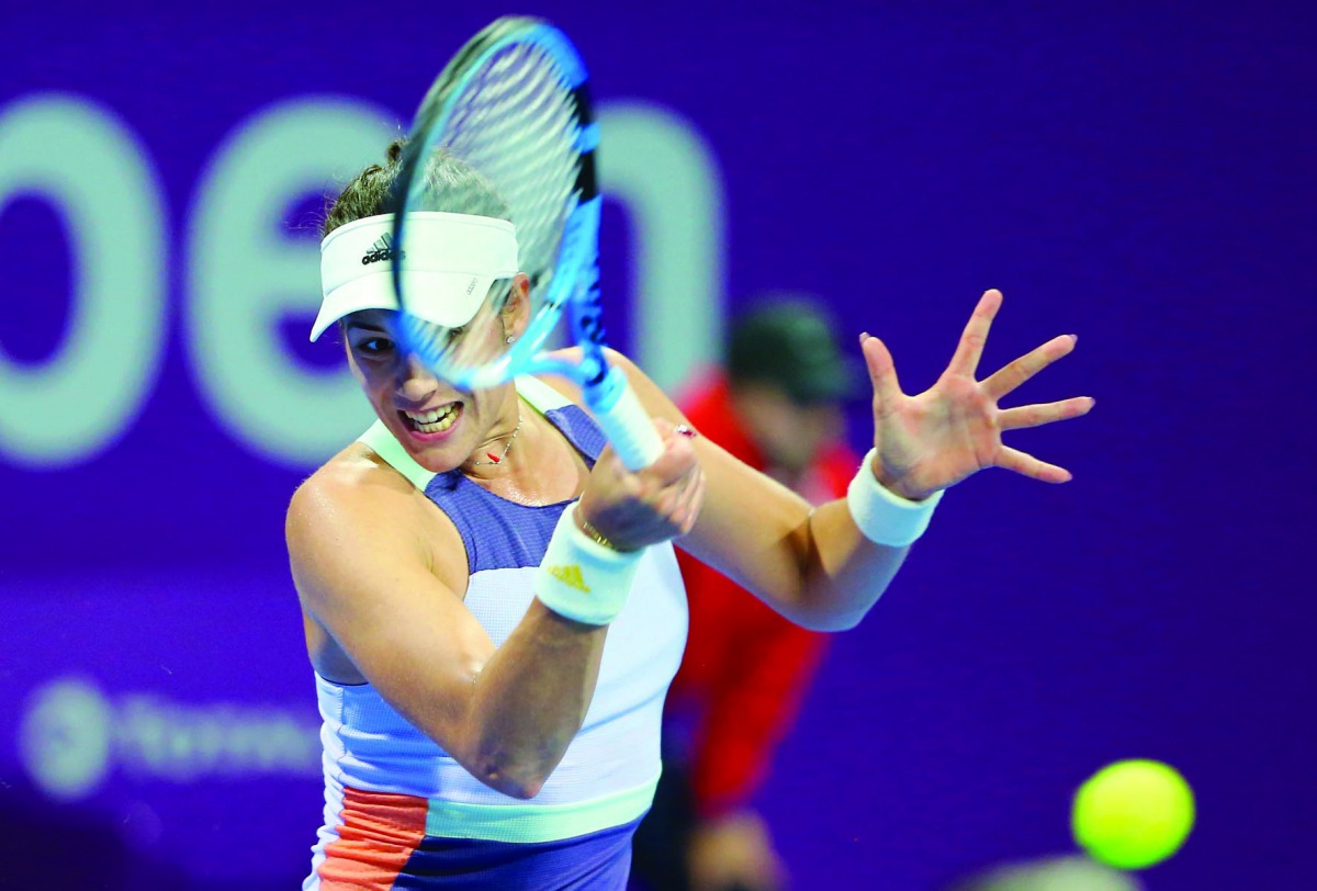 Garbine Muguruza of Spain returns the ball to Russia's Daria Kasatkina during their Round of 64 match of the Qatar Total Open at the Khalifa Tennis Complex in Doha, yesterday. Muguruza won 7-5, 5-7, 6-3.