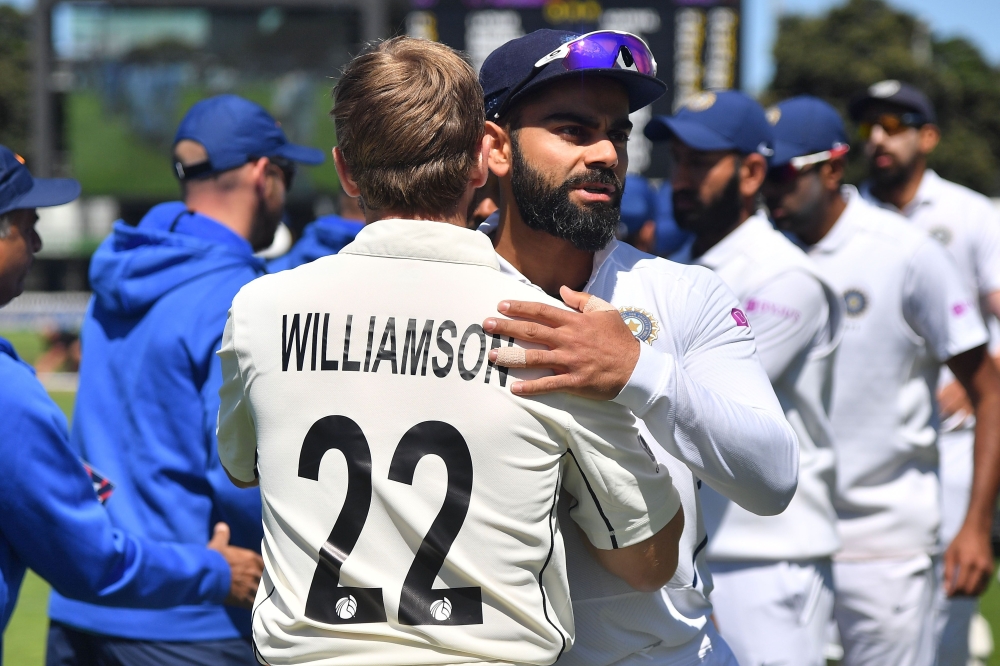 New Zealand's captain Kane Williamson (L) hugs India's captain Virat Kohli after New Zealand's win during day four of the first Test cricket match between New Zealand and India at the Basin Reserve in Wellington on February 24, 2020. / AFP / Marty MELVILL