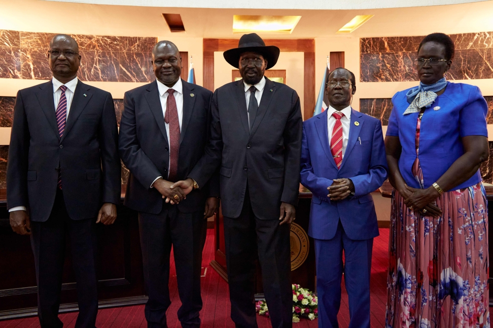 South Sudanes President Salva Kiir (3rd-L) shakes hands with First Vice President Dr Riek Machar (2nd-L) as Third Vice President Taban Deng Gai (L), Second Vice President James Wani Igga (2nd-R) and Fourth Vice President Rebecca Garang attend their sweari