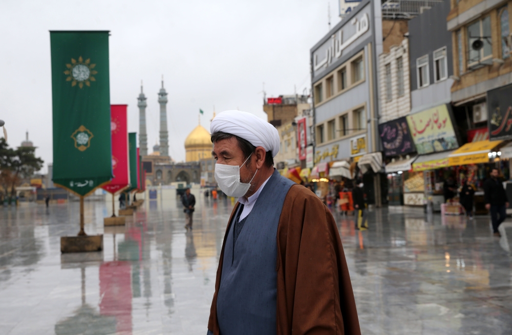  A man wears a respiratory mask after deaths and new confirmed cases revealed from the coronavirus in Qom, Iran on February 25, 2020. (Anadolu Agency) 
