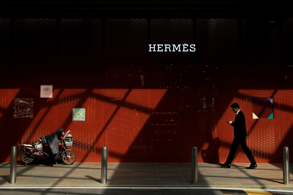 A man walks past a store of luxury goods retailer Hermes one day before the opening session of the National Peoples’ Congress in Beijing, China, March 4, 2019. Reuters / Thomas Peter
 