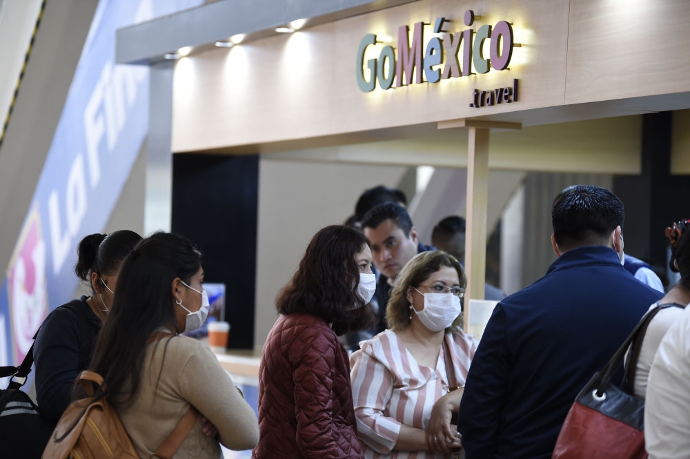 Passengers wearing protective masks are seen at the International Airport in Mexico City, on February 28, 2020. AFP / Alfredo Estrella
 