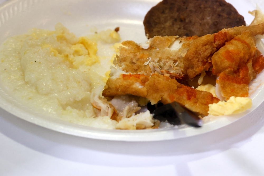 A breakfast plate of grits and fried fish is served to attendees as they listen to Bernie Sanders in St. George, South Carolina, February 28, 2020. Reuters/Jonathan Ernst
 