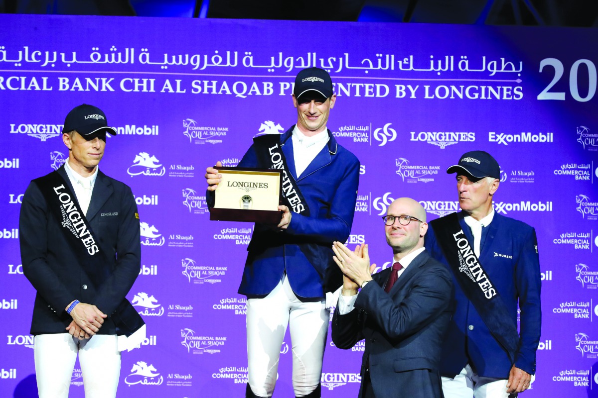Daniel Deusser (centre) receiving an award after winning the 2020 Commercial Bank CHI Al Shaqab Grand Prix. 
