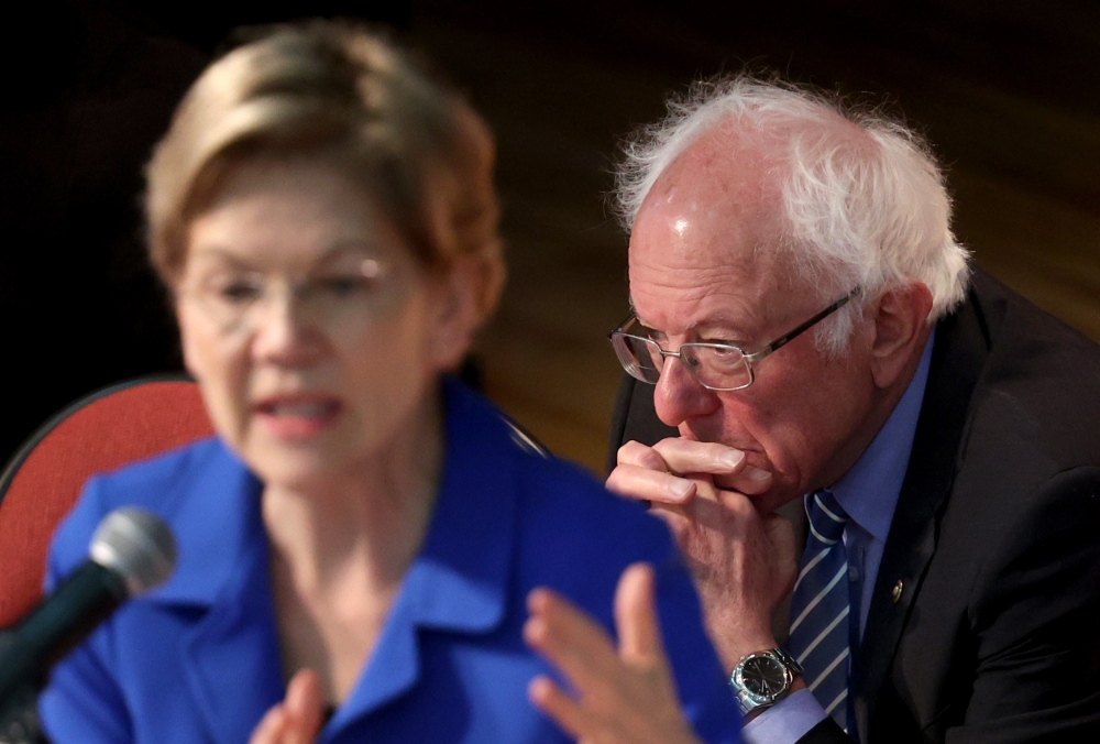 Democratic presidential candidate Sen. Bernie Sanders (I-VT) (R) listens as Sen. Elizabeth Warren (D-MA) speaks at the Ministers Breakfast hosted by National Action Network and Rev. Al Sharpton February 26, 2020 in North Charleston, South Carolina.  Win M