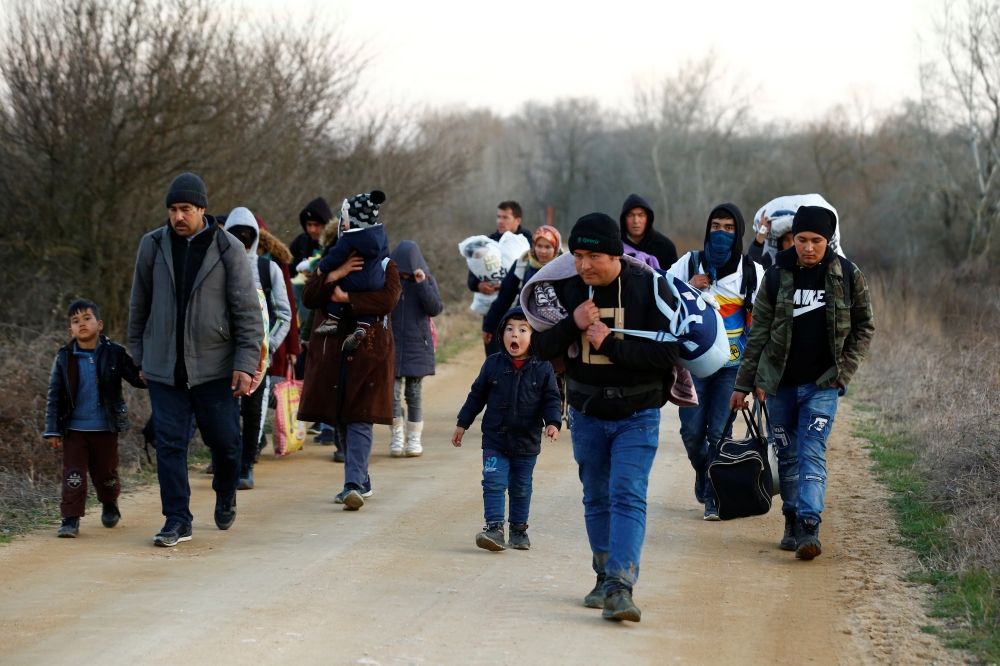 Migrants arrive to cross the Evros river to reach Greece as they are pictured from the Turkish border village of Elcili, Turkey March 1, 2020. Reuters/Huseyin Aldemir