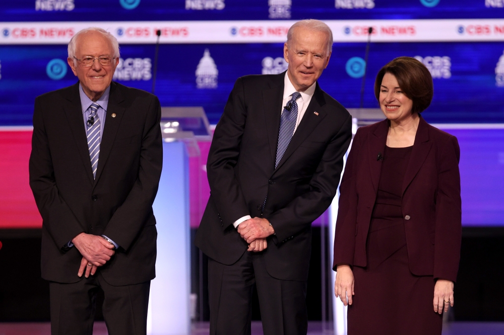 Democratic presidential candidates Sen. Bernie Sanders (I-VT), former Vice President Joe Biden, and Sen. Amy Klobuchar (D-MN) walk on stage before the Democratic presidential primary debate at the Charleston Gaillard Center on February 25, 2020 in Charles