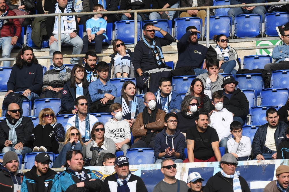 Soccer Football - Serie A - Lazio v Bologna - Stadio Olimpico, Rome, Italy - February 29, 2020 General view of fans wearing face masks in the stands due to the recent outbreak of coronavirus REUTERS/Alberto Lingria 